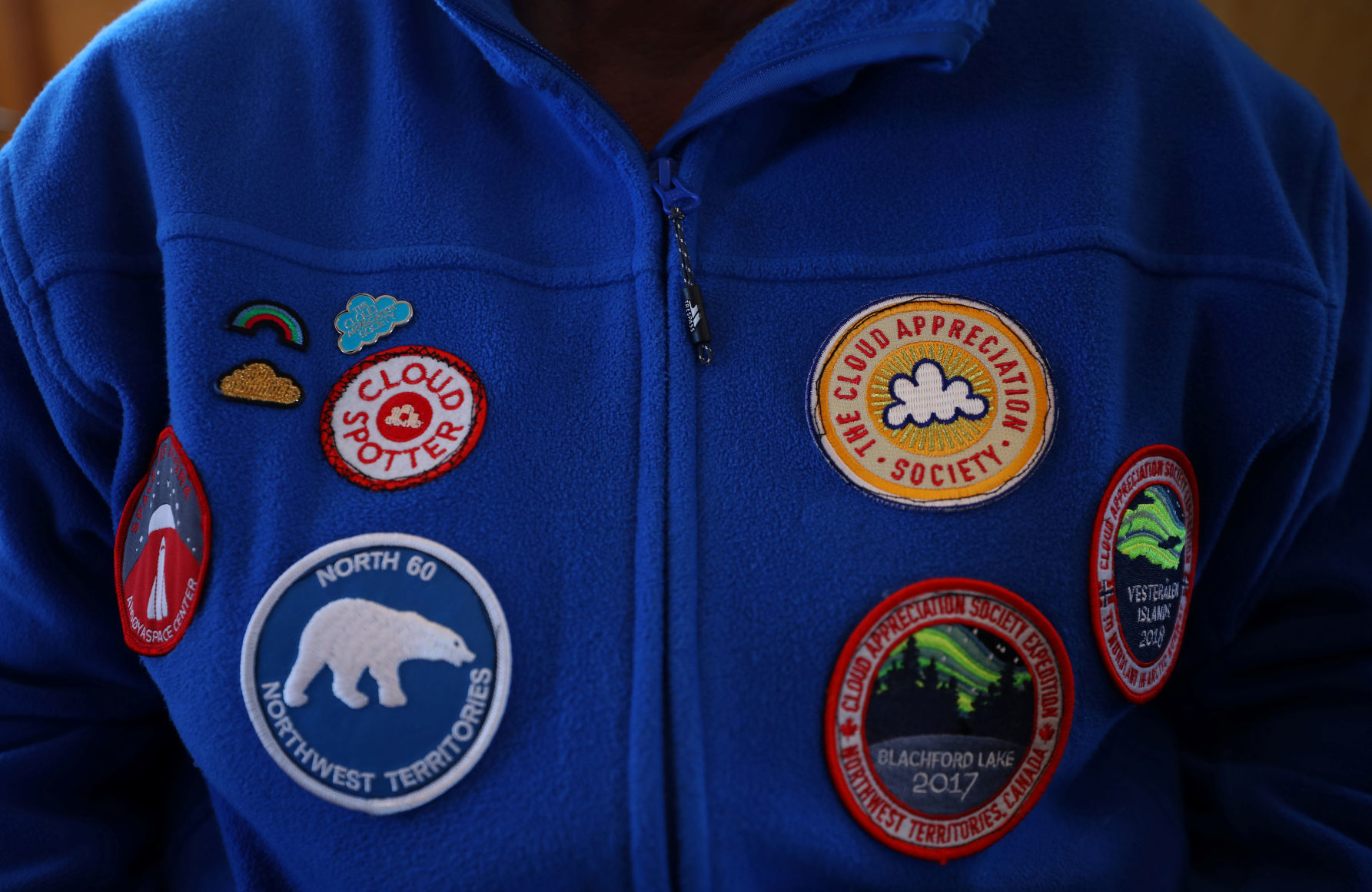 Patches are seen on the fleece jacket of a member of the Cloud Appreciation Society Margaret Harwood as she travels on the ferry from Lundy